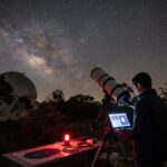 Ilustração de nave espacial sobrevoando planeta com símbolo de interrogação, representando busca por vida extraterrestre.